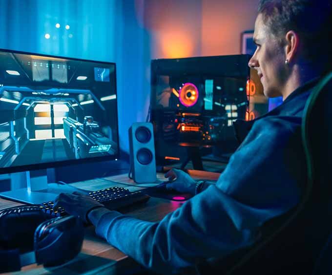 computer gamer sat playing his desk